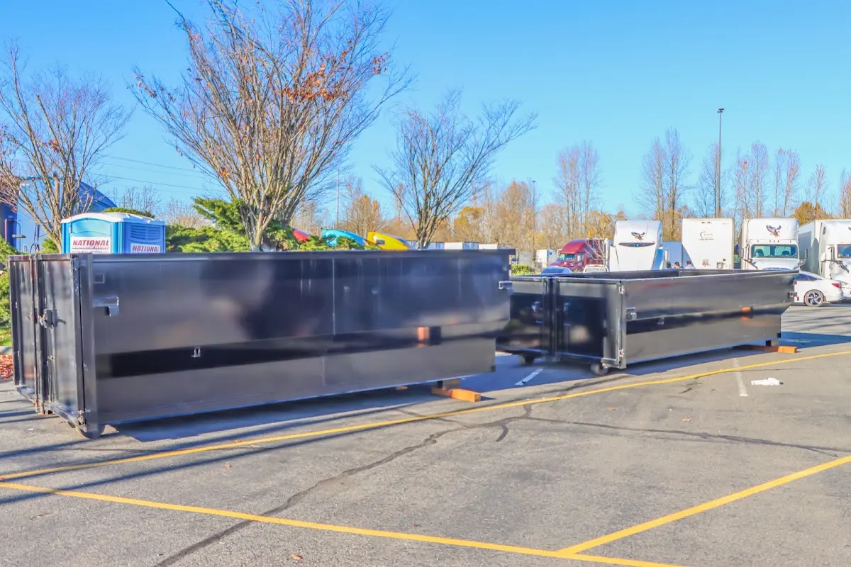 Professional dumpster rental service with roll-off container on residential driveway in Goulds